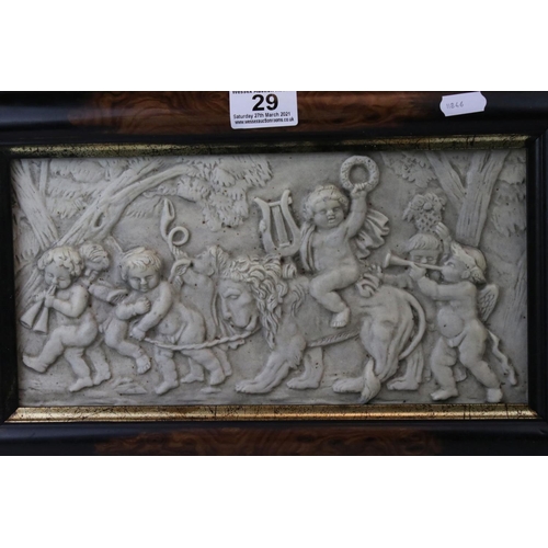 29 - A composite stone framed panel decorated with cherubs playing with a lion one riding on the lions ba... 