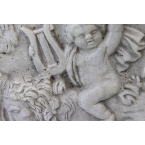 29 - A composite stone framed panel decorated with cherubs playing with a lion one riding on the lions ba... 