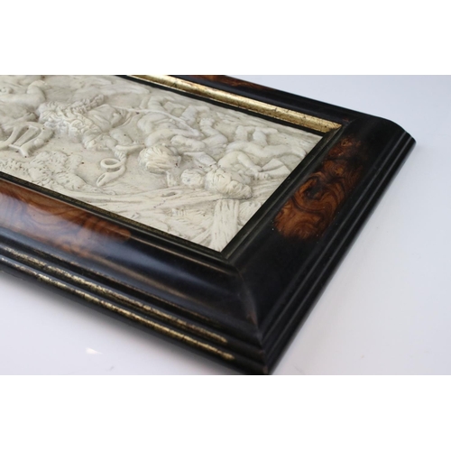 29 - A composite stone framed panel decorated with cherubs playing with a lion one riding on the lions ba... 