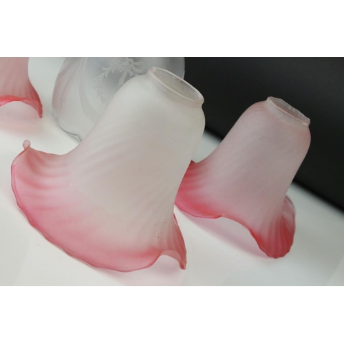 35 - Four early 20th century pink and vaseline glass shades of naturalistic form and two others.