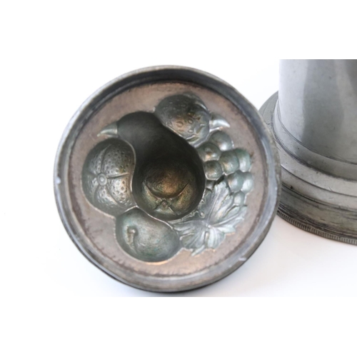 45 - An Antique pewter lidded mould the lid decorated with fruit has removable base which is stamped no 4... 