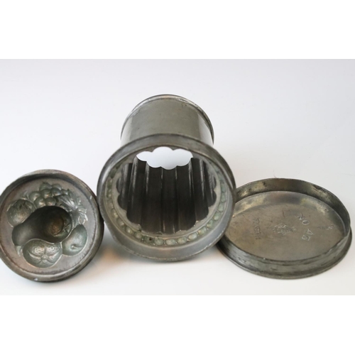 45 - An Antique pewter lidded mould the lid decorated with fruit has removable base which is stamped no 4... 