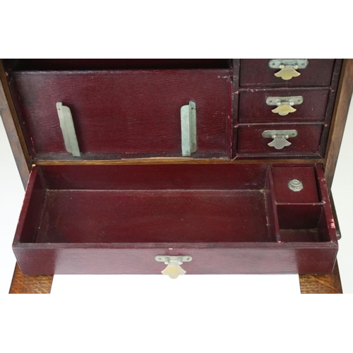 121 - An early 20th century oak stationary cabinet with fitted interior and brass mounts.