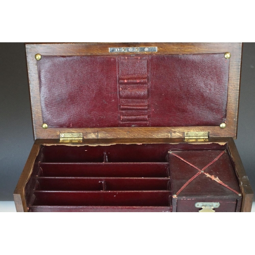 121 - An early 20th century oak stationary cabinet with fitted interior and brass mounts.