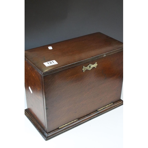 121 - An early 20th century oak stationary cabinet with fitted interior and brass mounts.