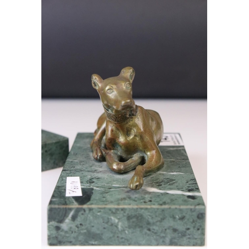 143 - A pair of gilt bronze models of seated greyhounds, together with a pair of bronze dolphin candlestic... 