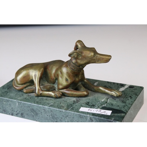 143 - A pair of gilt bronze models of seated greyhounds, together with a pair of bronze dolphin candlestic... 