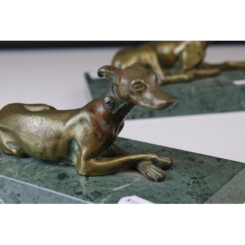 143 - A pair of gilt bronze models of seated greyhounds, together with a pair of bronze dolphin candlestic... 