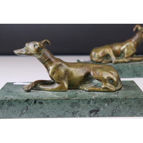 143 - A pair of gilt bronze models of seated greyhounds, together with a pair of bronze dolphin candlestic... 