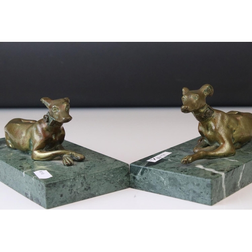 143 - A pair of gilt bronze models of seated greyhounds, together with a pair of bronze dolphin candlestic... 
