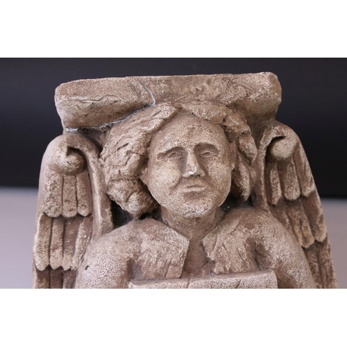 148 - A plaster wall bracket of medieval design in the form of an Angel holding a shield.