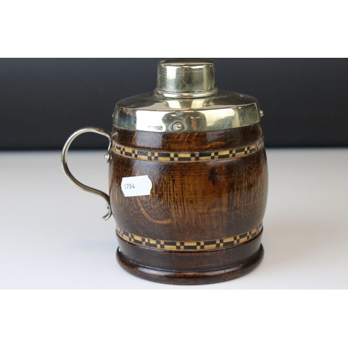 149 - A 20th century oak and plated tea caddy in the form of a cup or tankard.
