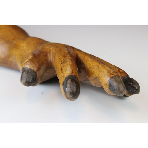 153 - A carved wooden treen human arm.