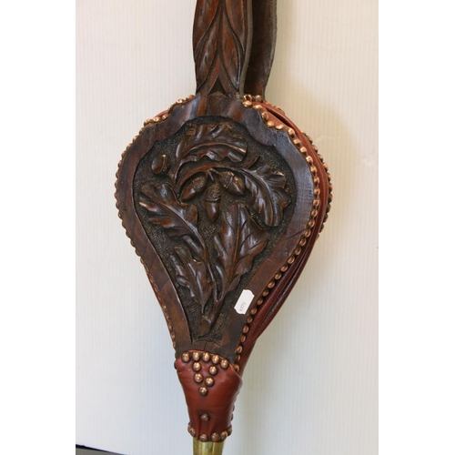 164 - A pair of antique wooden and brass bellows with carved oak leaf decoration.