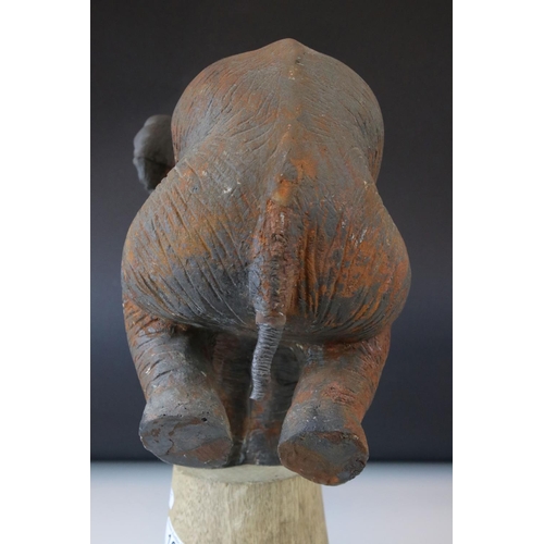 165 - A novelty model of a circus Elephant standing on a plinth with his front legs.