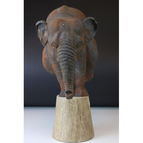 165 - A novelty model of a circus Elephant standing on a plinth with his front legs.