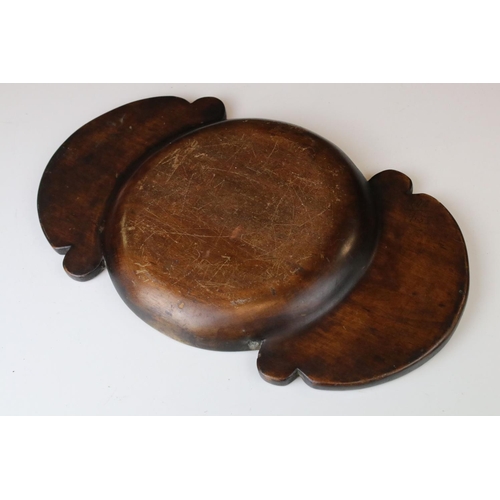 172 - An antique wooden treen collection bowl the handles carved with stylized fish.
