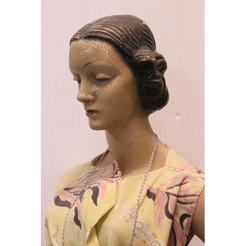 173 - A mid 20th century artist posed model of a lady in dress mounted on plinth.