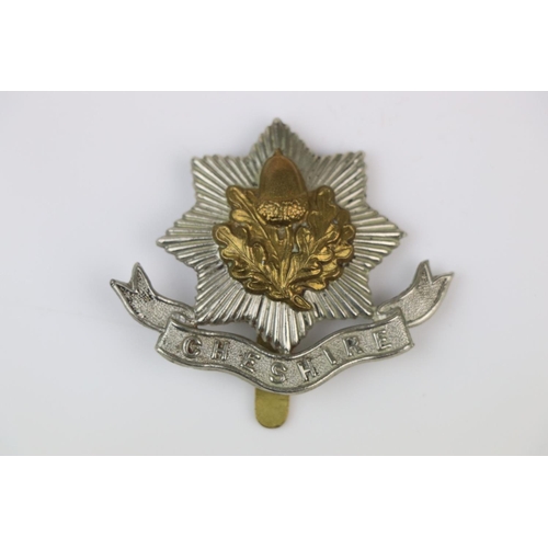 10 - A British The Cheshire Regiment Bi-Metal Cap Badge With Slide Fixing To The Verso.