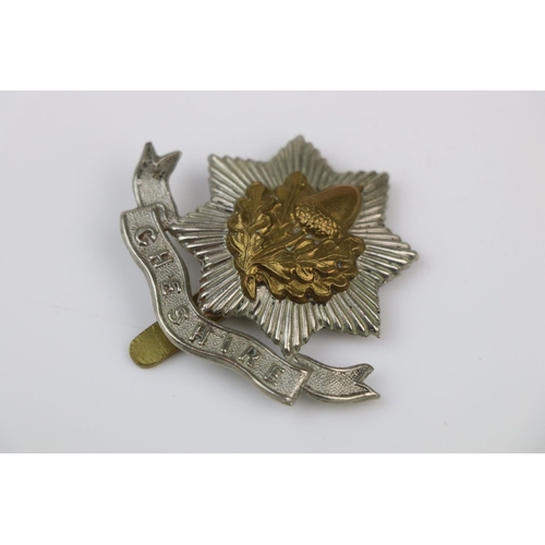 10 - A British The Cheshire Regiment Bi-Metal Cap Badge With Slide Fixing To The Verso.