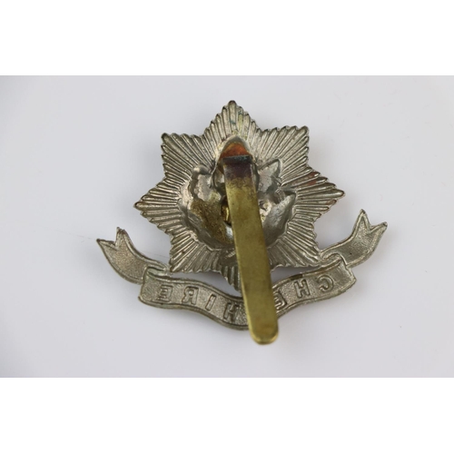 10 - A British The Cheshire Regiment Bi-Metal Cap Badge With Slide Fixing To The Verso.