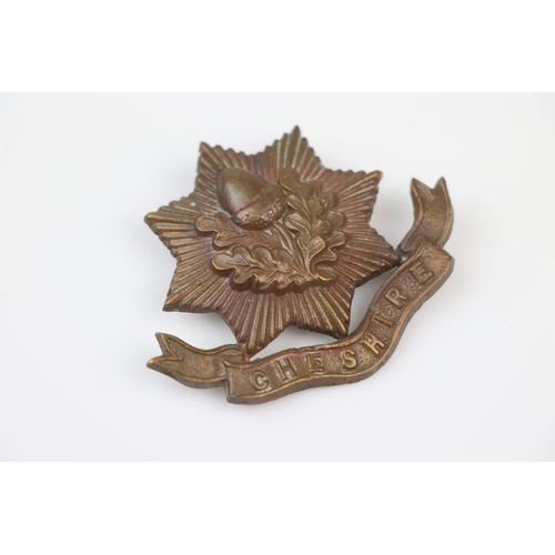 6 - A British The Cheshire Regiment Bronze Cap Badge With Twin Blade Fixings To The Verso.