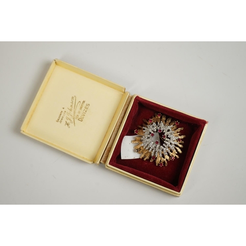 298 - A vintage starburst brooch together with a heart pendant.