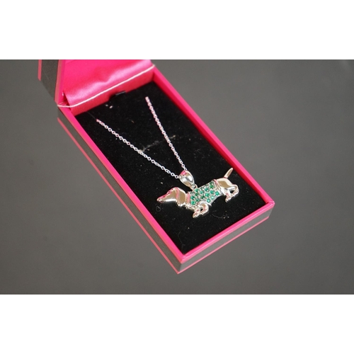 302 - Silver sausage dog pendant necklace with ruby eye
