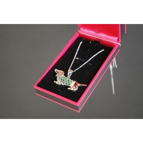 302 - Silver sausage dog pendant necklace with ruby eye