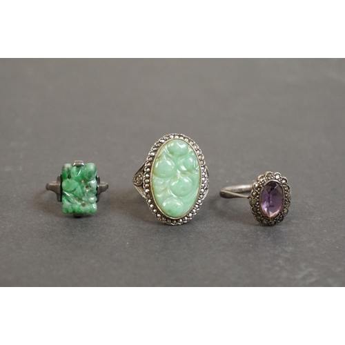 305 - Three silver rings comprising circa 1920s jade ring, a jade and marcasite dress ring, together with ... 