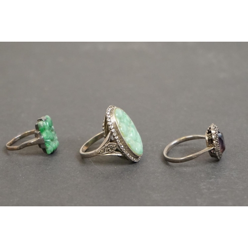 305 - Three silver rings comprising circa 1920s jade ring, a jade and marcasite dress ring, together with ... 