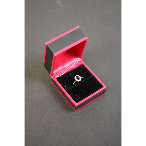 312 - 18ct white gold amethyst and diamond cluster ring of 52 points