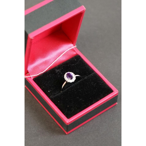 312 - 18ct white gold amethyst and diamond cluster ring of 52 points
