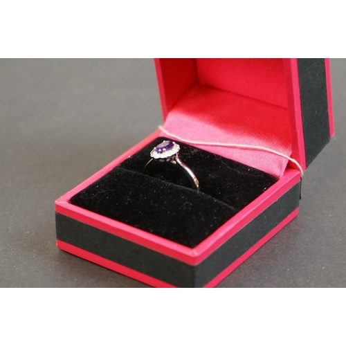 312 - 18ct white gold amethyst and diamond cluster ring of 52 points