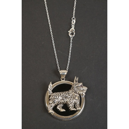 321 - Silver pendant necklace of dog form with ruby eye