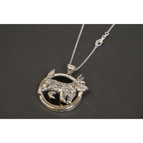 321 - Silver pendant necklace of dog form with ruby eye
