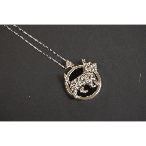 321 - Silver pendant necklace of dog form with ruby eye