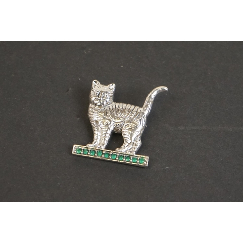 328 - Silver cat brooch on emerald style platform base