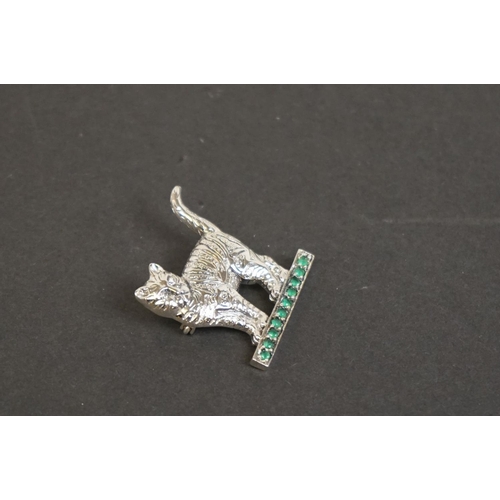 328 - Silver cat brooch on emerald style platform base