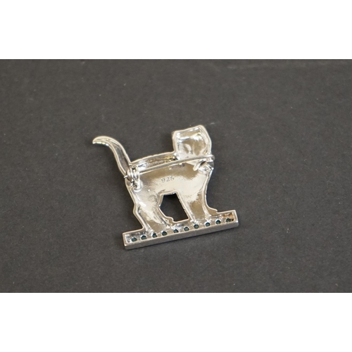 328 - Silver cat brooch on emerald style platform base