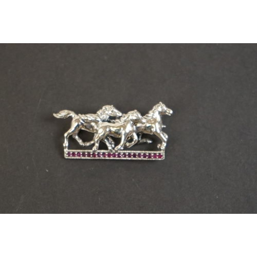 332 - Silver horse brooch on ruby platform
