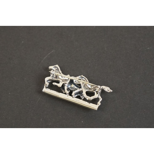 332 - Silver horse brooch on ruby platform