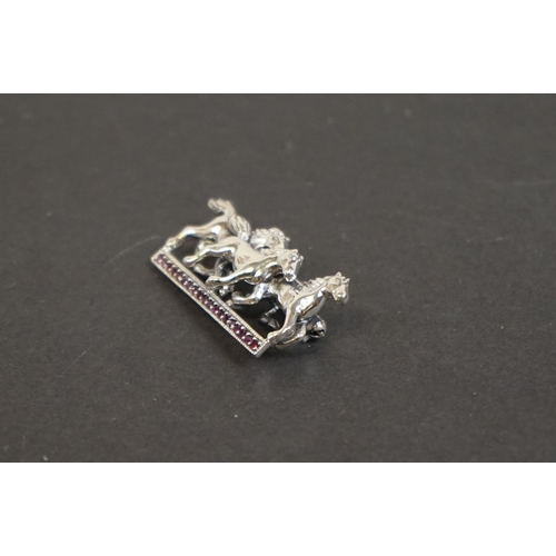 332 - Silver horse brooch on ruby platform