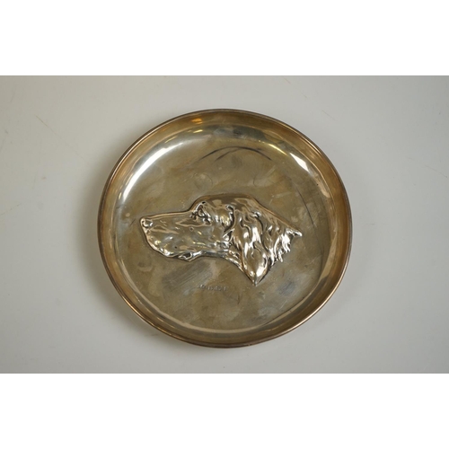343 - A silver pin tray with hounds head decoration, by John Rose, Birmingham, 1908, 13cm diameter