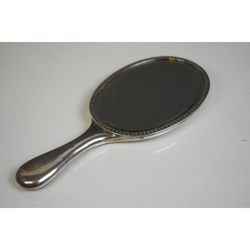 349 - A fully hallmarked sterling silver hand mirror together with two hallmarked silver topped scent bott... 