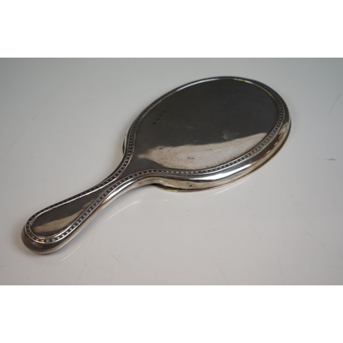 349 - A fully hallmarked sterling silver hand mirror together with two hallmarked silver topped scent bott... 