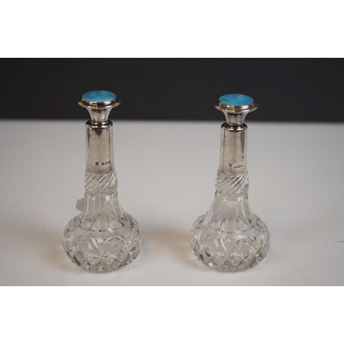 349 - A fully hallmarked sterling silver hand mirror together with two hallmarked silver topped scent bott... 