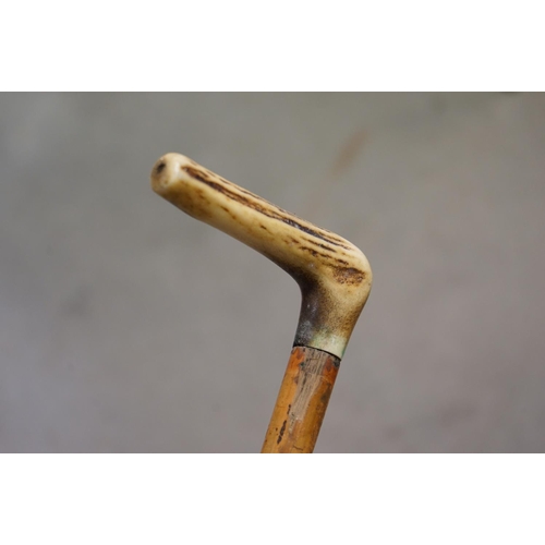 366 - Walking Stick with Brass Handle in the form of a Skull together with a Walking Stick with Antler Han... 