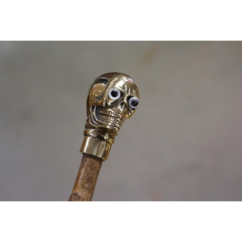366 - Walking Stick with Brass Handle in the form of a Skull together with a Walking Stick with Antler Han... 