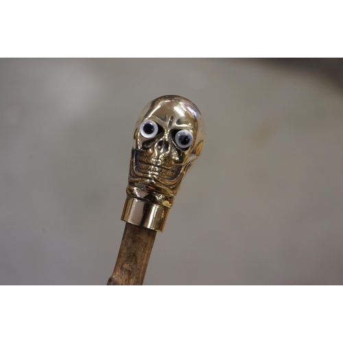 366 - Walking Stick with Brass Handle in the form of a Skull together with a Walking Stick with Antler Han... 